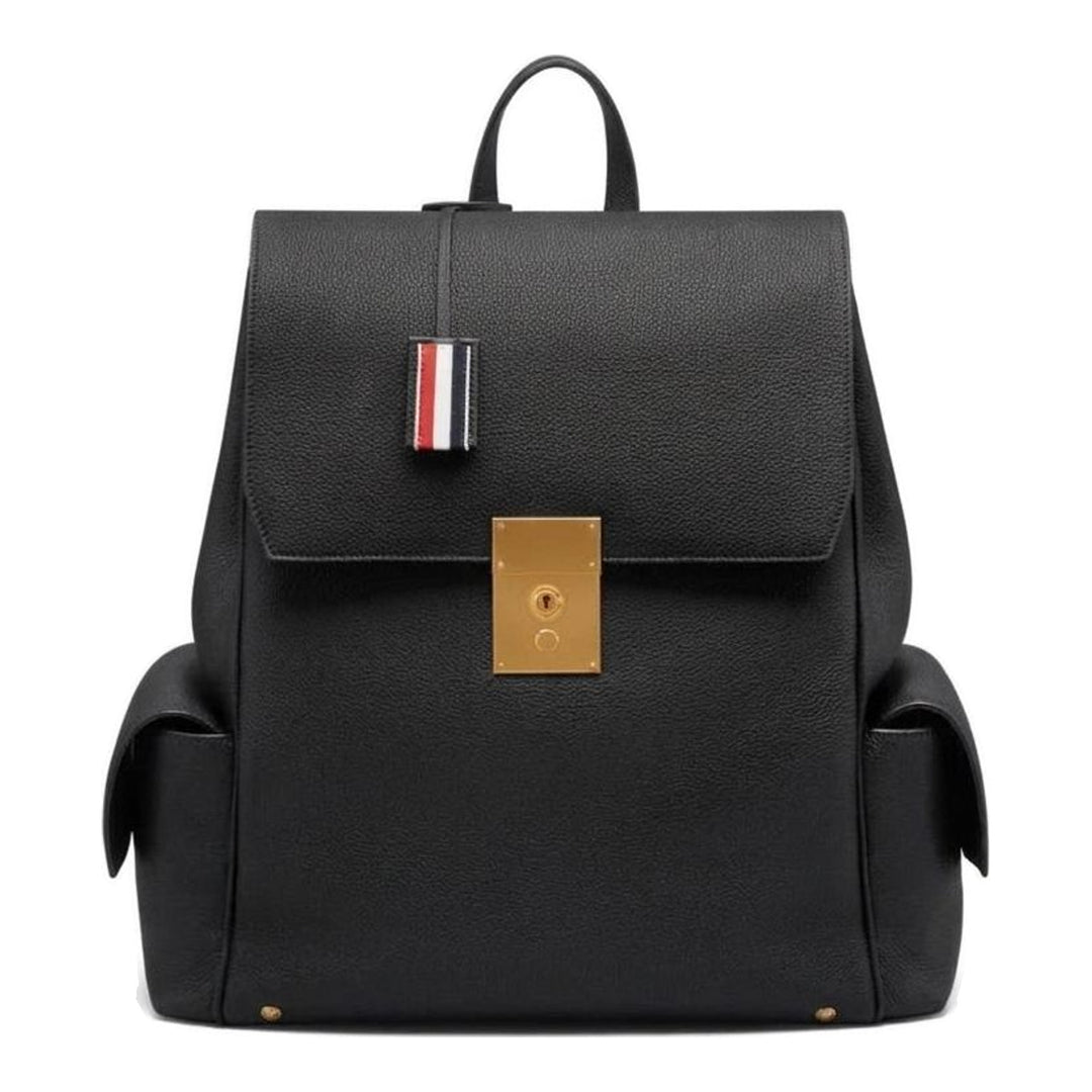 Thom Browne Bolton backpack in black soft pebble leather with brass-tone lock closure, flap side pockets, and red, white, and blue tab detail - packshot