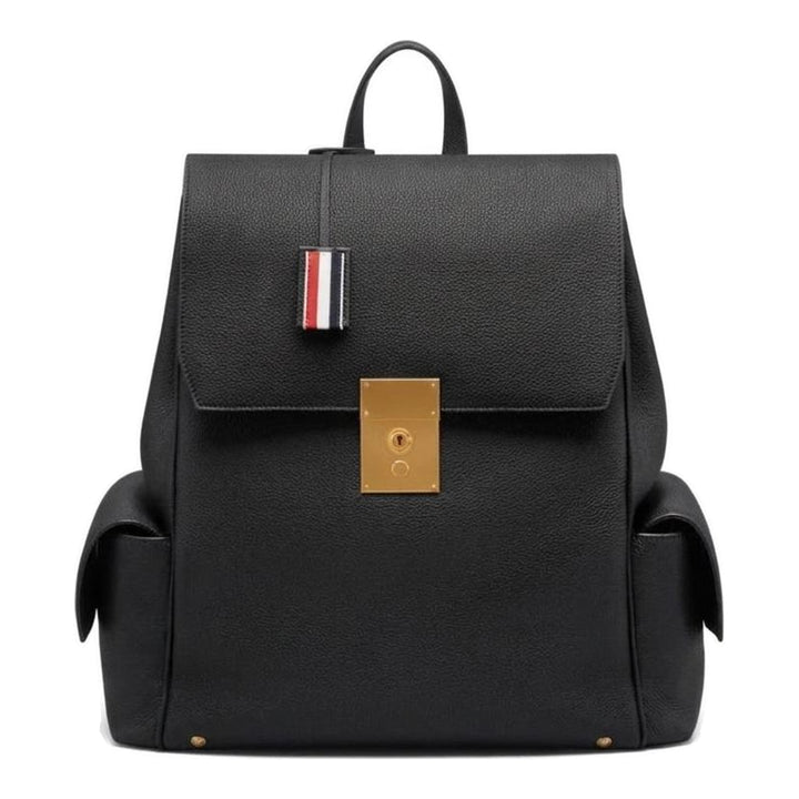 Thom Browne Bolton backpack in black soft pebble leather with brass-tone lock closure, flap side pockets, and red, white, and blue tab detail - packshot