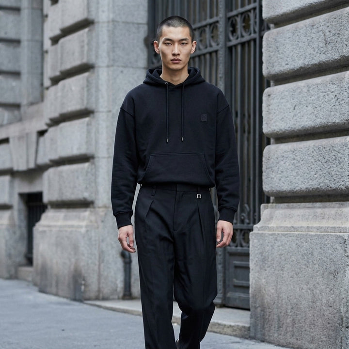 Wooyoungmi black pullover hoodie with drawstring hood, kangaroo pocket and tonal logo patch on the chest - lifestyle