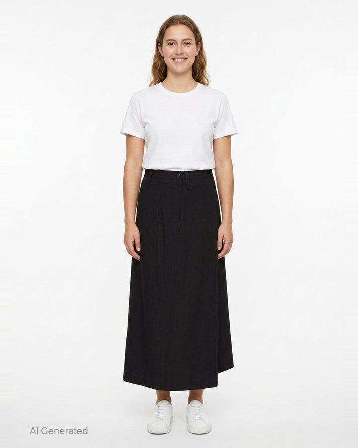 Y's black structured cloth maxi skirt with asymmetric hem, patch pocket, and tailored waistband with button fastening - front